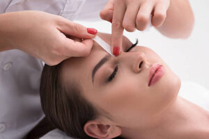 woman getting her brows waxed