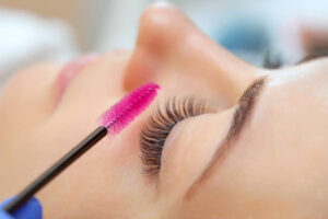 woman getting her lashes brushed out