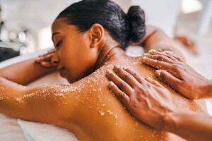 woman getting her back exfoliated