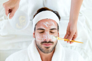 male getting a mask applied to his face