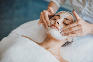 woman getting a mask applied to her face